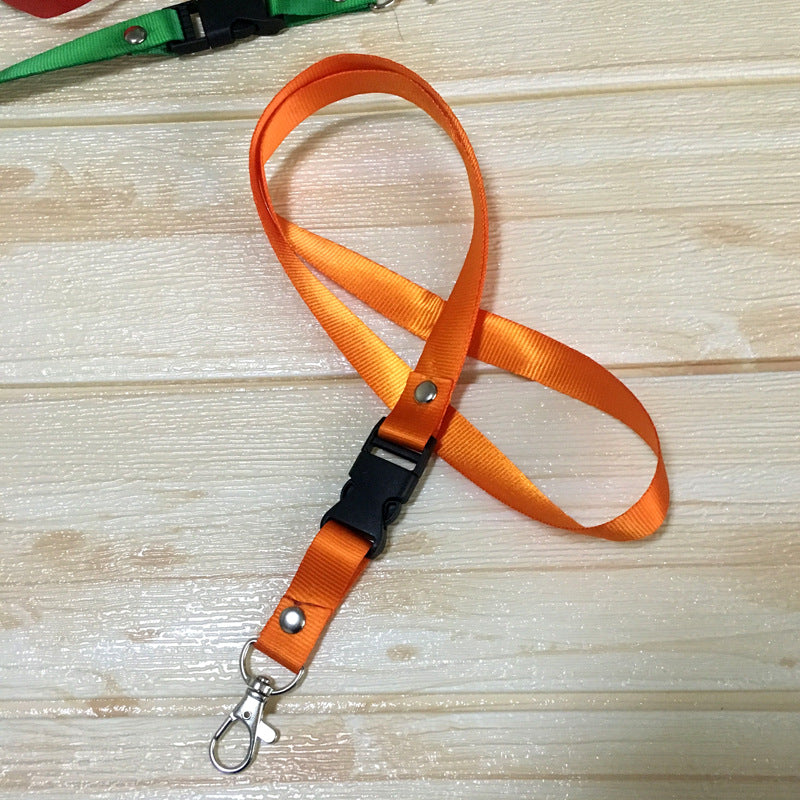 Orange custom nylon lanyard with a detachable plastic buckle, silver button snaps, and a metal lobster clip, arranged in a loop on a white background.