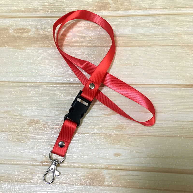 Red custom nylon lanyard with a detachable plastic buckle, silver button snaps, and a metal lobster clip, arranged in a loop on a white background.