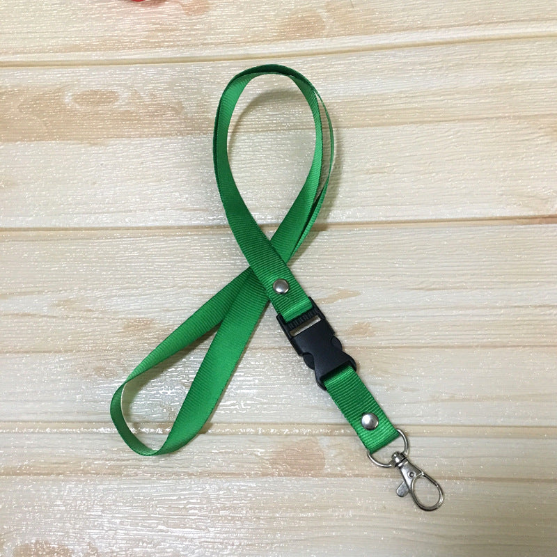 Green custom nylon lanyard with a detachable plastic buckle, silver button snaps, and a metal lobster clip, arranged in a loop on a white background.