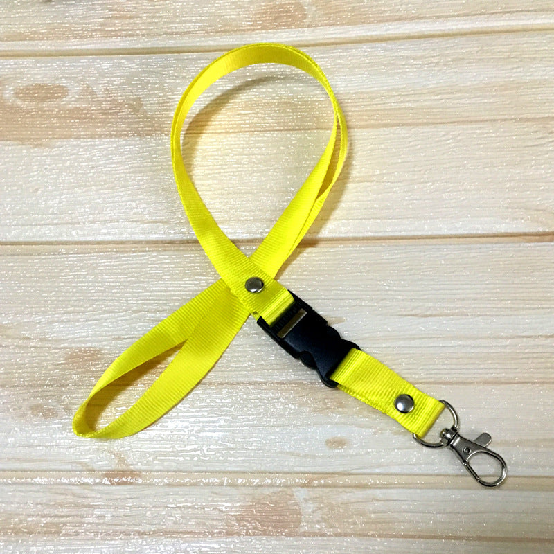 Yellow custom nylon lanyard with a detachable plastic buckle, silver button snaps, and a metal lobster clip, arranged in a loop on a white background.
