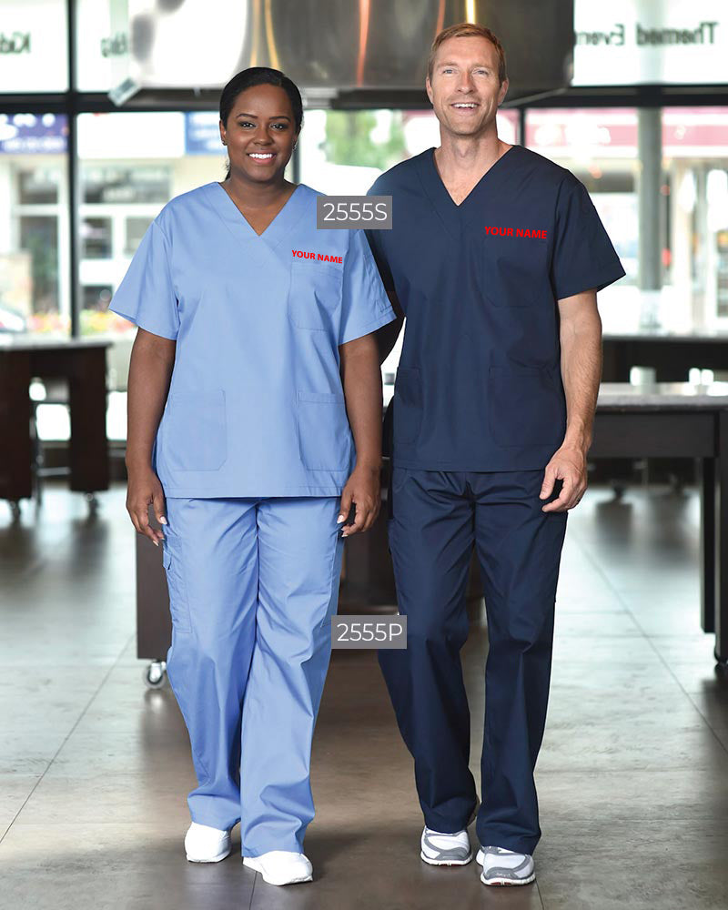 Two models wearing the Premium Unisex V-Neck Scrub Set - Logo Embroidered; the woman is in a light blue V-neck top (style 2555S) and matching pants (style 2555P), while the man wears a navy V-neck top (style 2555S) with coordinating pants (style 2555P), both featuring red embroidered 'YOUR NAME' text on the chest.