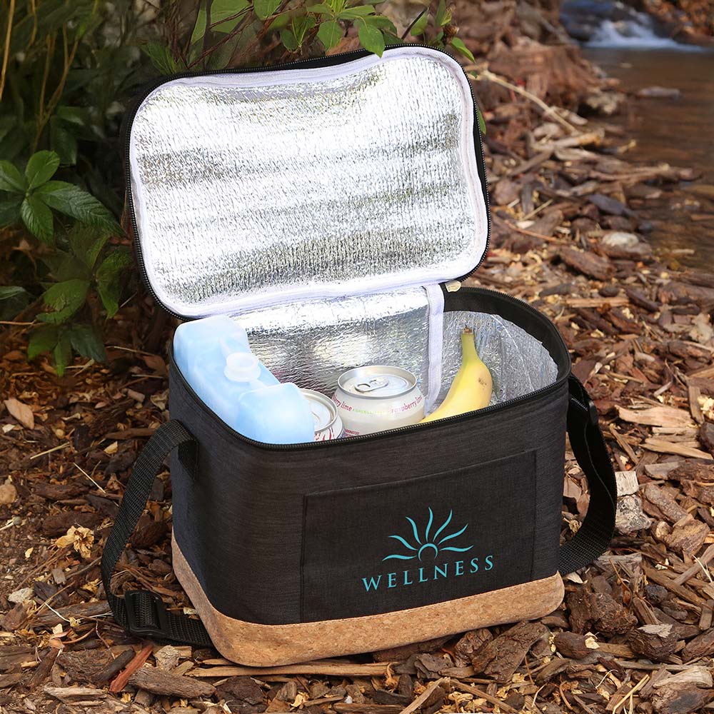 Top-angle view of open black insulated cooler bag with cork bottom, showing reflective lining