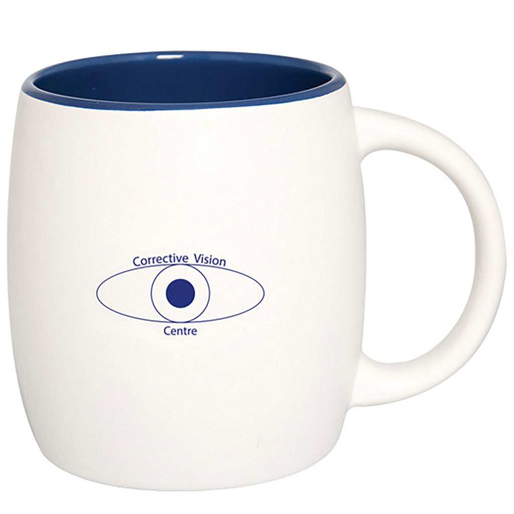 White ceramic mug with blue interior, featuring an eye-shaped logo in blue.