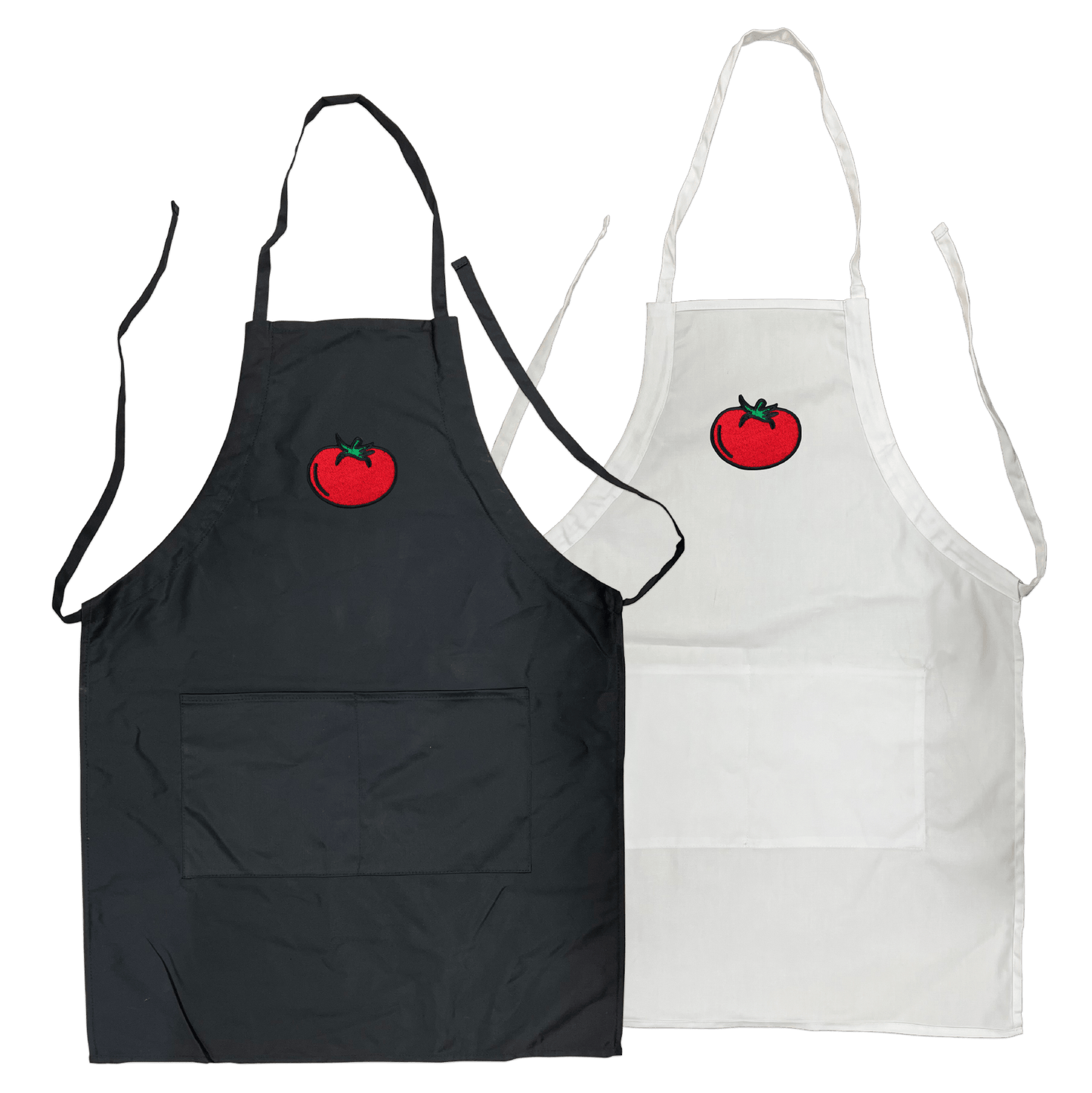 Black and white polyester-cotton aprons, each with front pockets and an embroidered red tomato logo on the chest area.