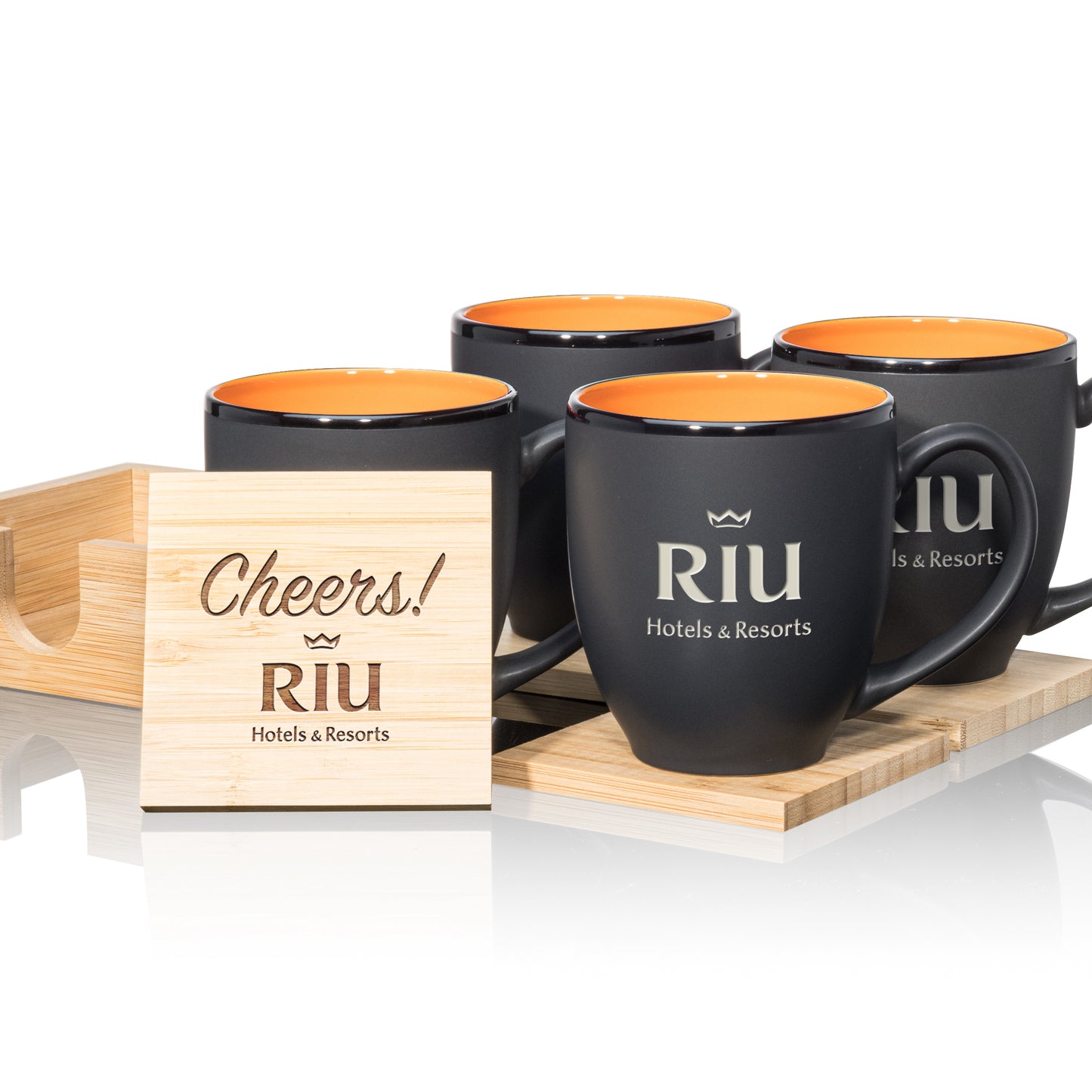 Matte black mugs with orange interiors, paired with engraved wooden coasters in a stylish gift set.