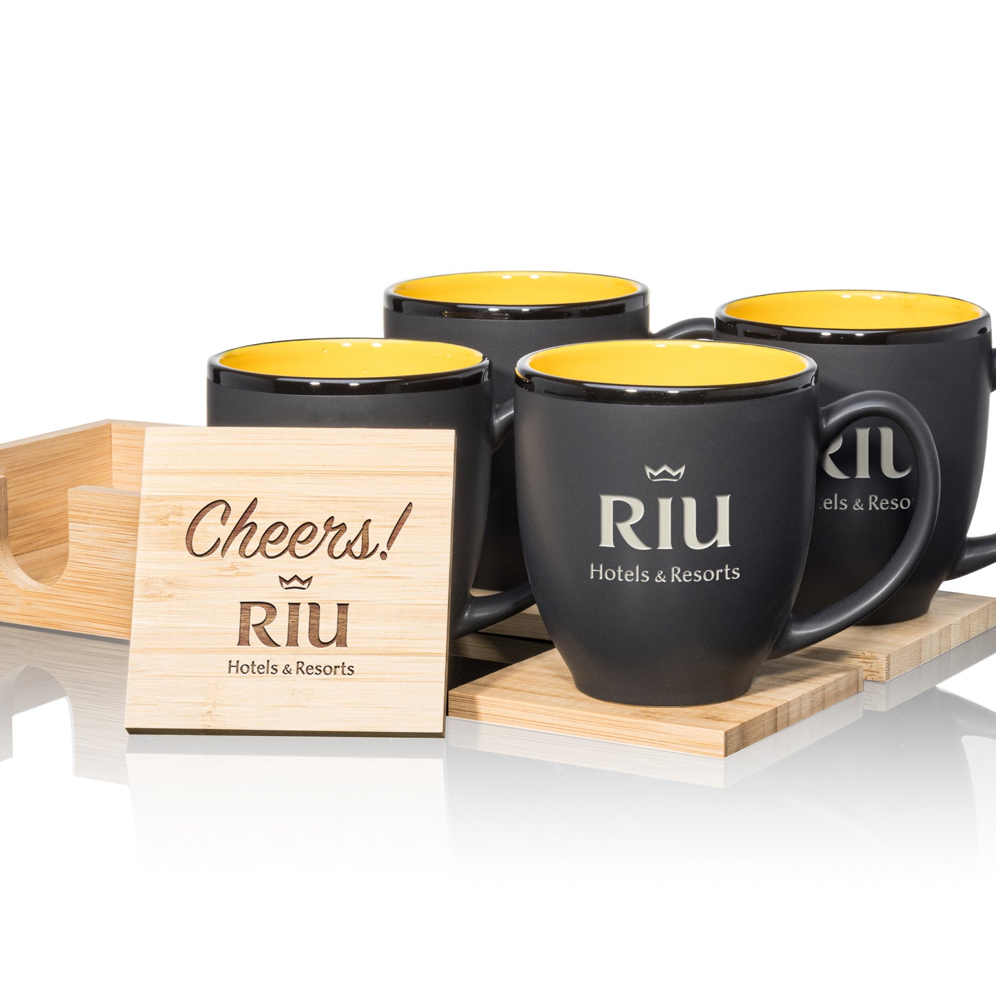 Matte black mugs with yellow interiors, paired with engraved wooden coasters in a stylish gift set.