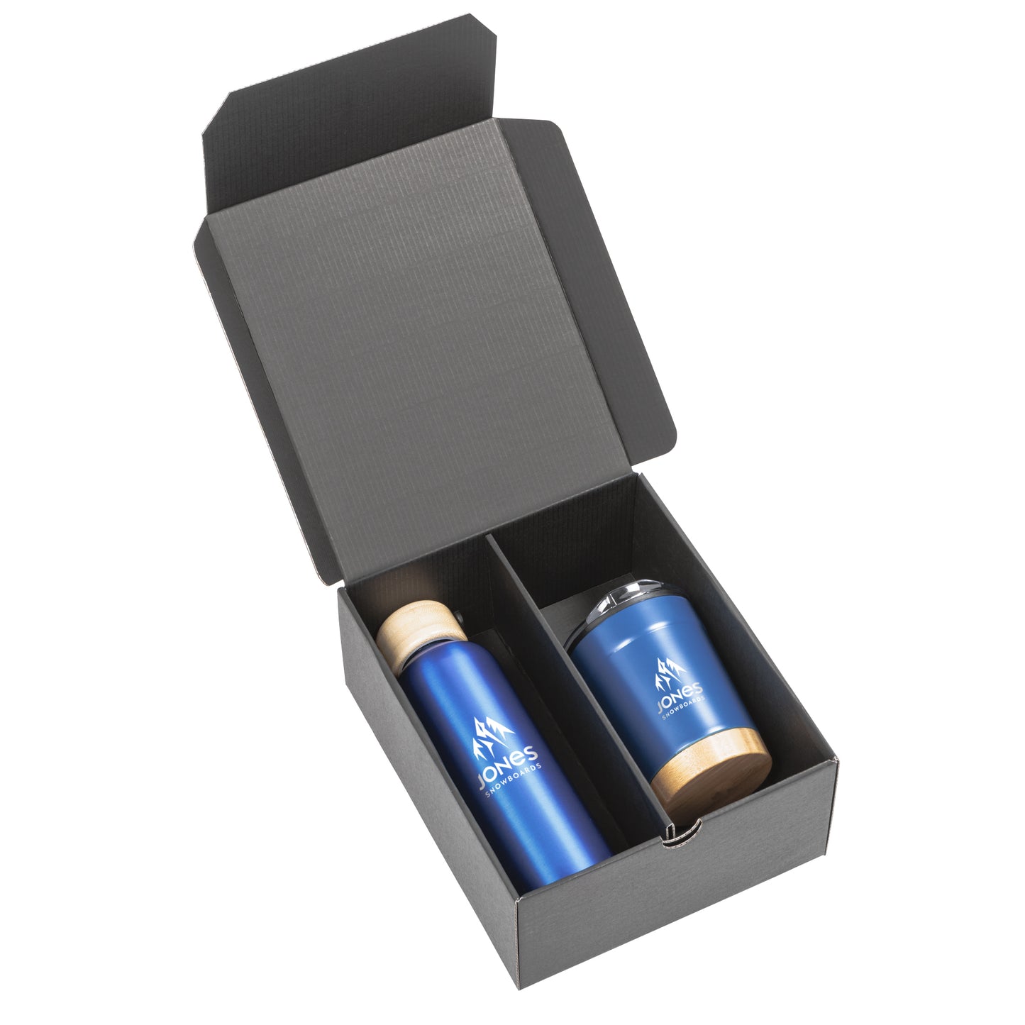 Black gift box containing a matte blue stainless steel bottle with a bamboo lid and a matching tumbler with bamboo base and clear lid, both branded with the Jones Snowboards logo in white.