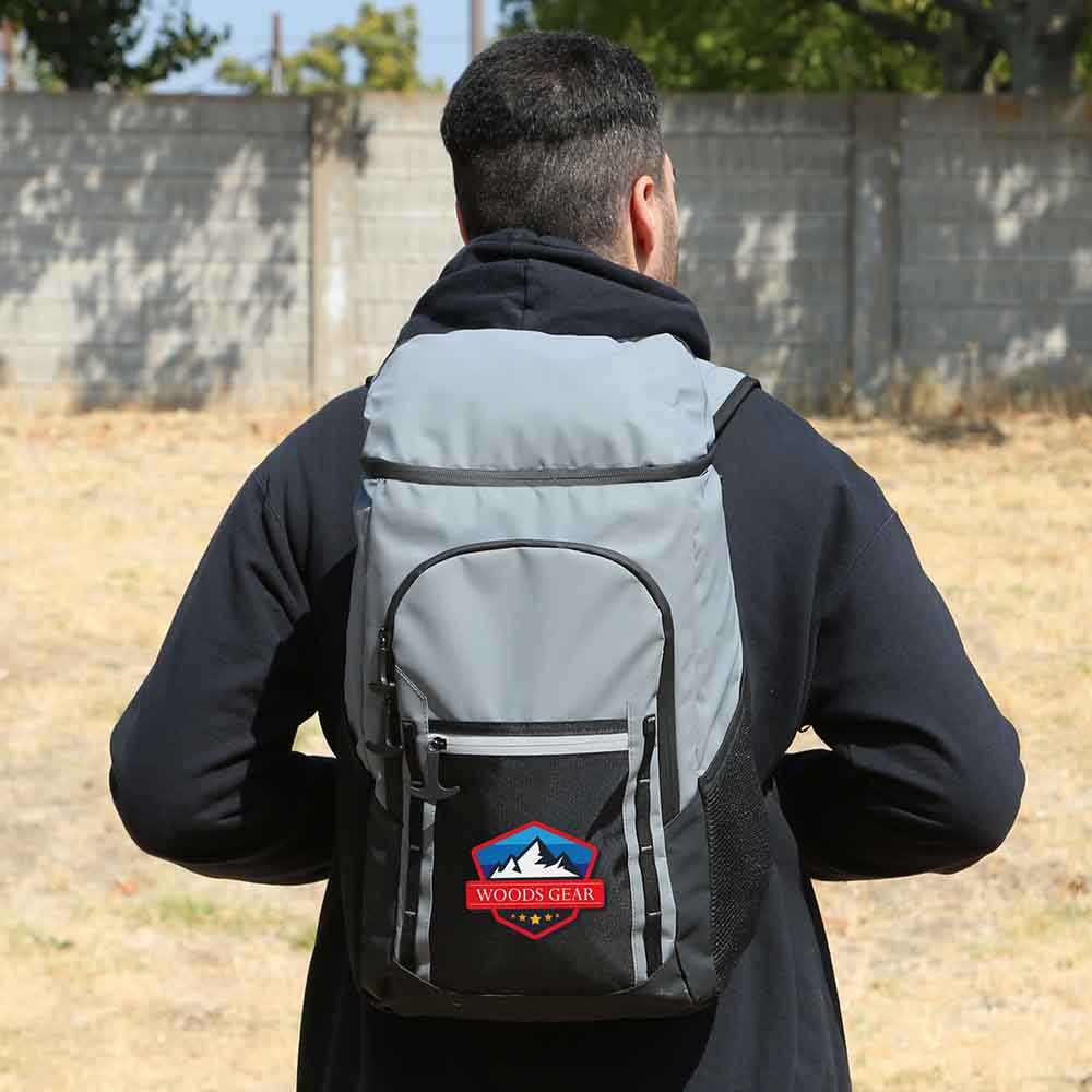 Large grey and black hiking backpack with front zippered pocket, smaller compartment, side mesh pockets, and custom logo