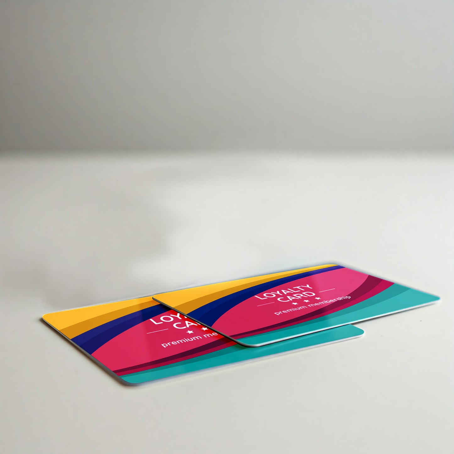 Colorful loyalty cards with a bold, modern design featuring curved stripes in pink, yellow, blue, and teal, labeled “LOYALTY CARD +ID” and “premium membership.”