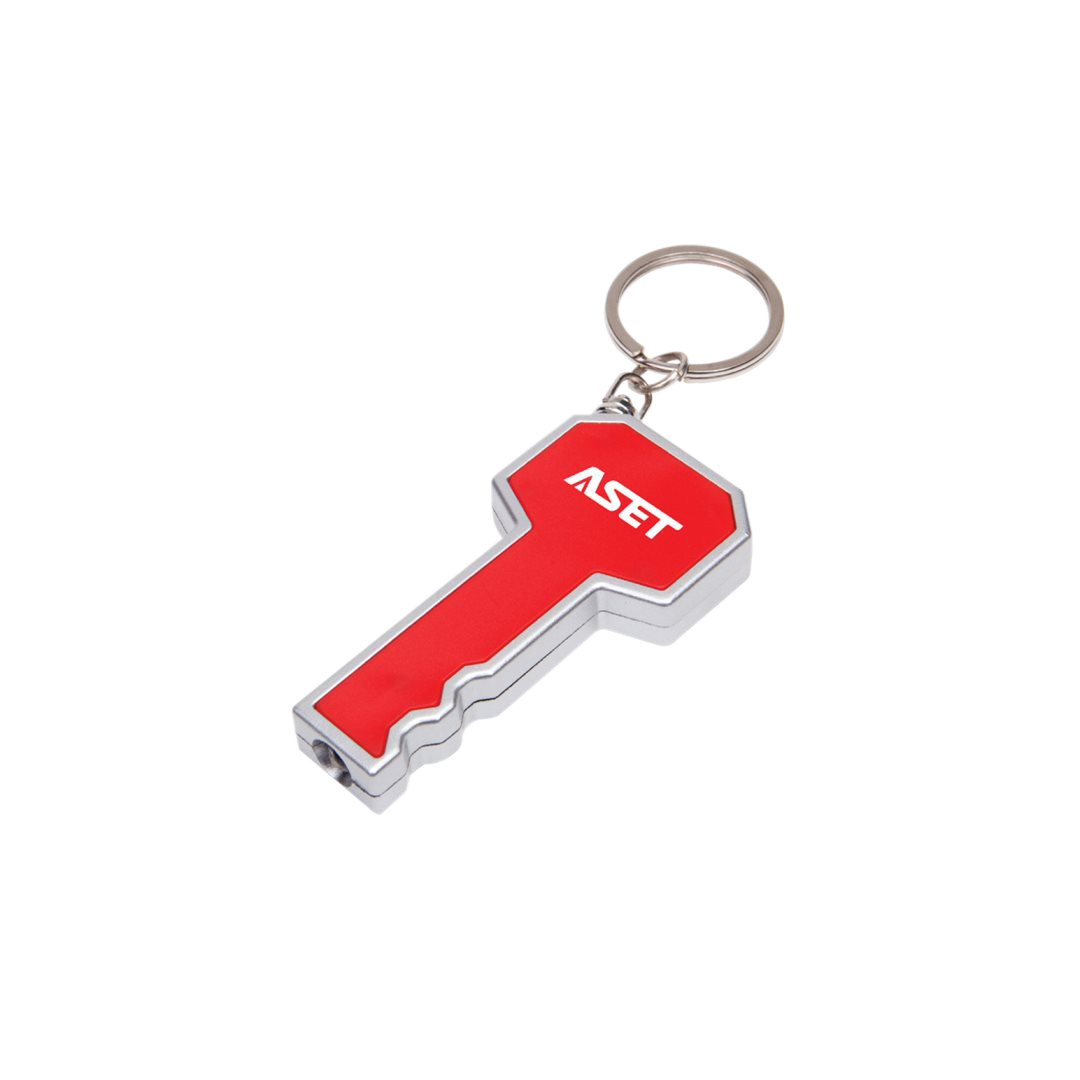 Key-shaped LED flashlight keychain in red and silver, featuring a bright white light at the tip and a customized 'ASET' logo printed on the head; includes a metal keyring for easy attachment.