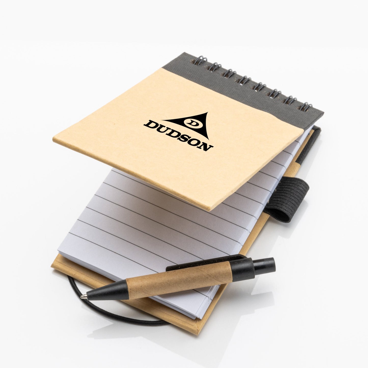 Eco-friendly spiral notepad with kraft paper cover, black binding, and lined pages, shown open with matching black and kraft pen placed on top.