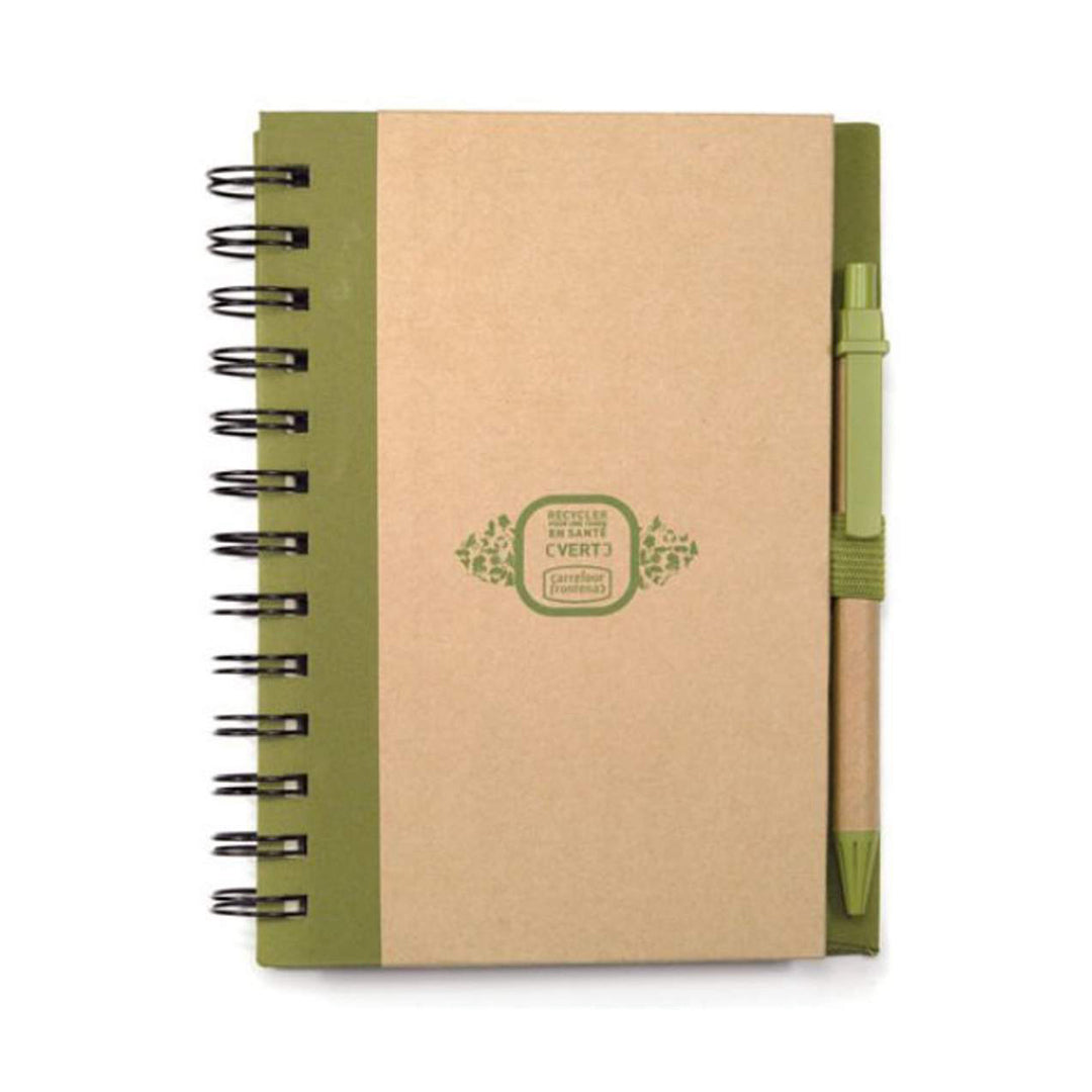 Eco-friendly spiral-bound notebook with a kraft paper cover, black spine, and pen holder on the right side, featuring a matching green-ink pen and a logo printed on the front.
