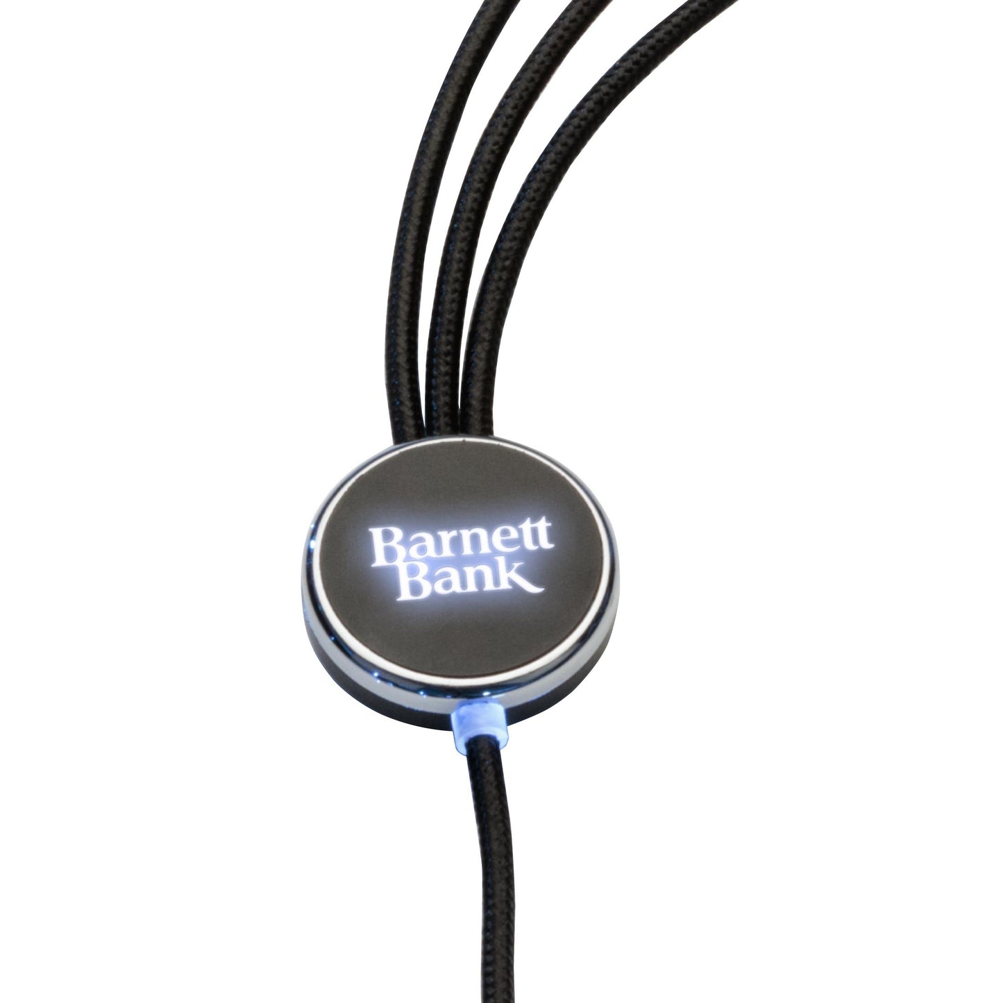 Close-up view of the Fuller Light-Up Multi-Charge Cable hub with customized glowing white 'Barnett Bank' logo illuminated at the center of the round metallic casing.