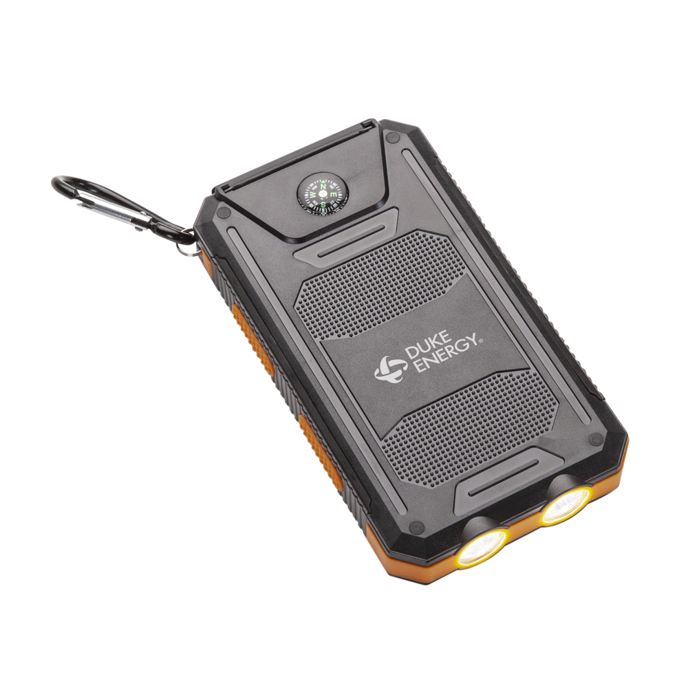 Black rugged solar power bank with a built-in compass, dual LED flashlights, and a carabiner; features the white "Duke Energy" logo on the front panel.