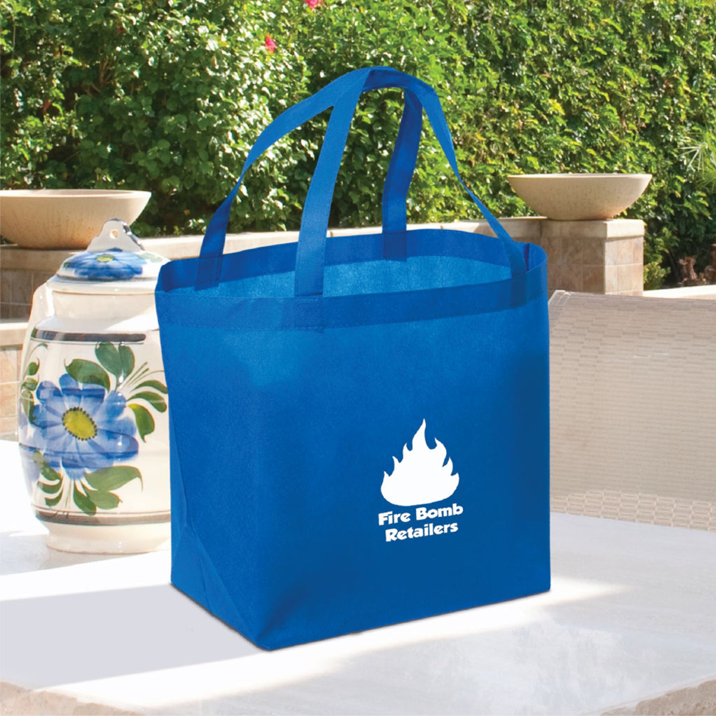 Royal blue reusable shopping tote with dual handles and Fire Bomb Retailers logo