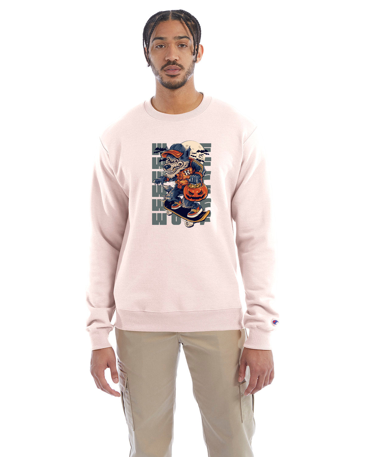 Body blush crewneck sweatshirt with a Halloween-themed graphic of a cartoon werewolf skateboarding with a pumpkin basket, worn by a model in beige pants.
