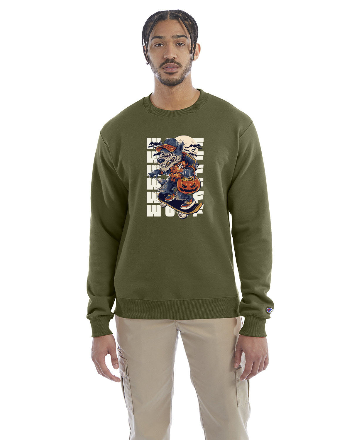 Fresh olive crewneck sweatshirt with a Halloween-themed graphic of a cartoon werewolf skateboarding with a pumpkin basket, worn by a model in beige pants.