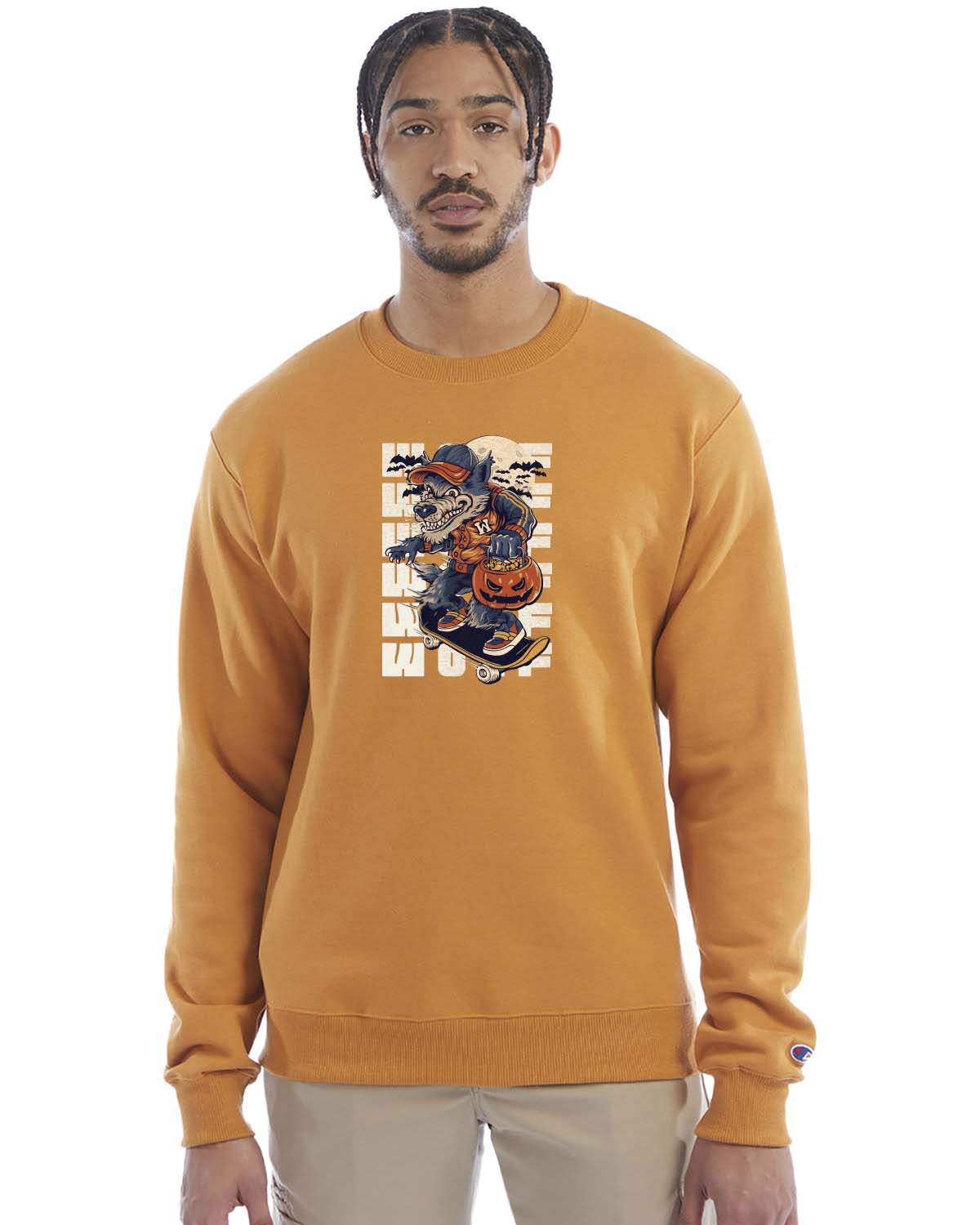 Gold glint crewneck sweatshirt with a Halloween-themed graphic of a cartoon werewolf skateboarding with a pumpkin basket, worn by a model in beige pants.