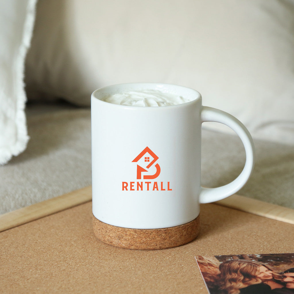 White ceramic mug with a cork base, featuring a custom logo