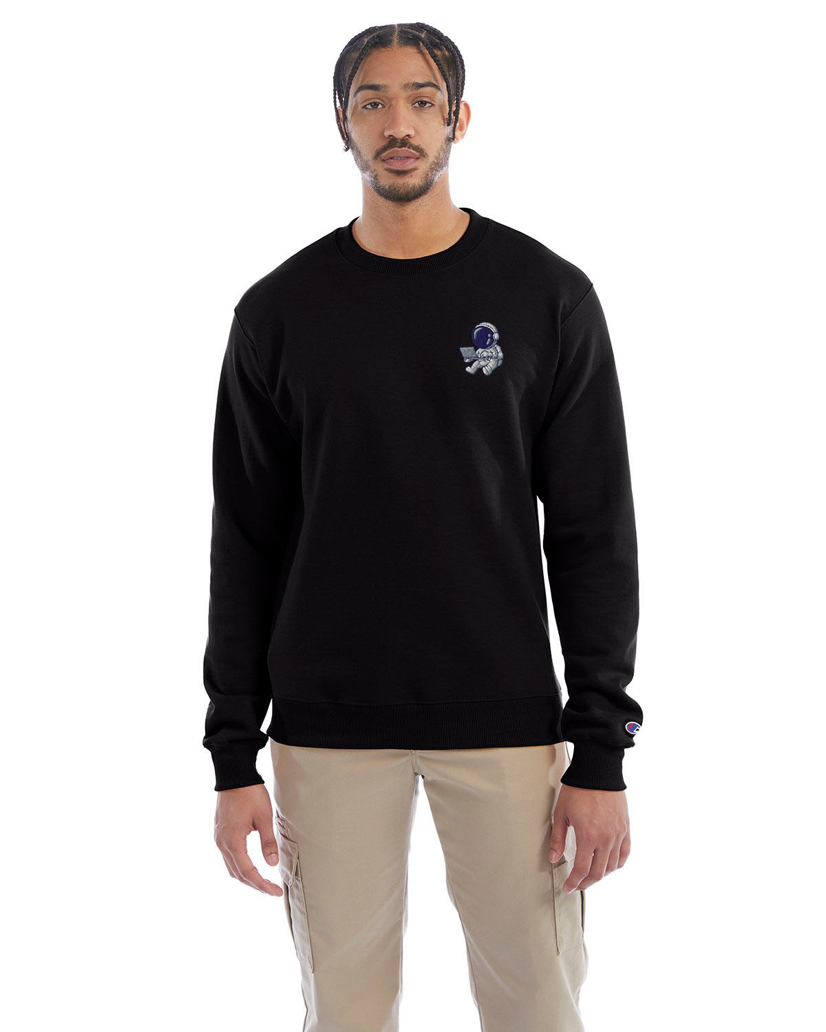 Model wearing black Champion crewneck sweatshirt with custom chest logo.