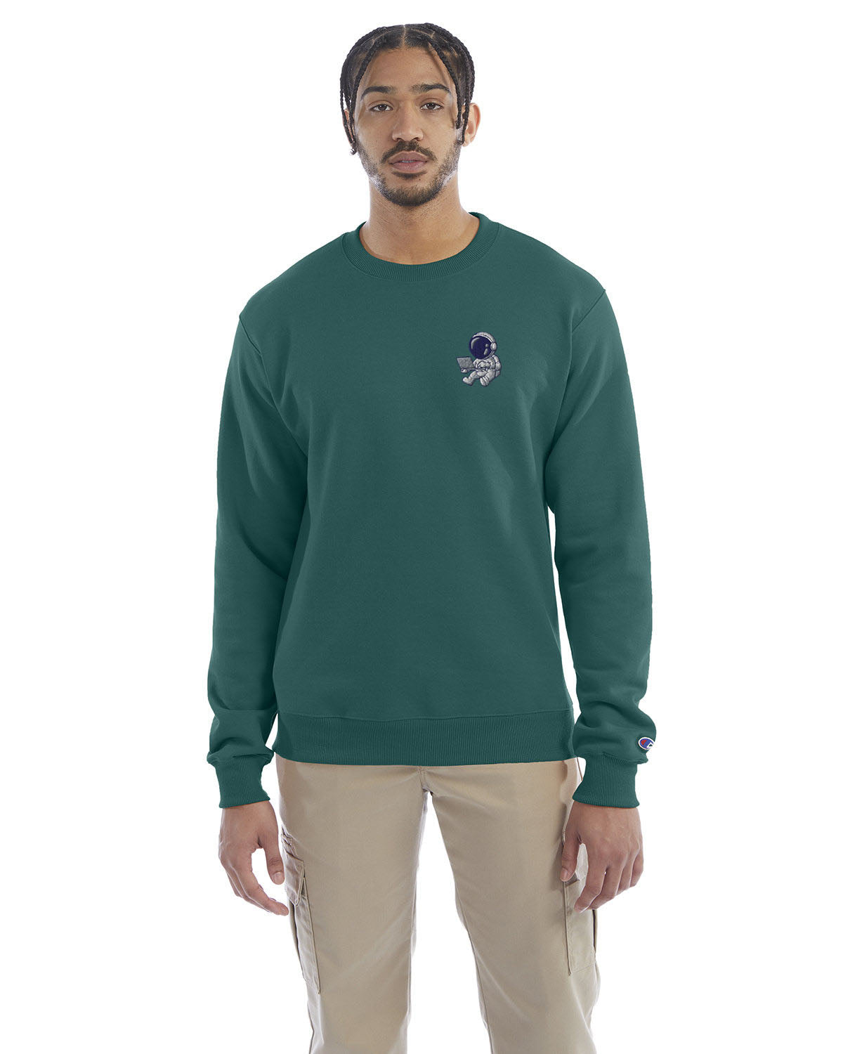 Model wearing emerald green Champion crewneck sweatshirt with custom chest logo.