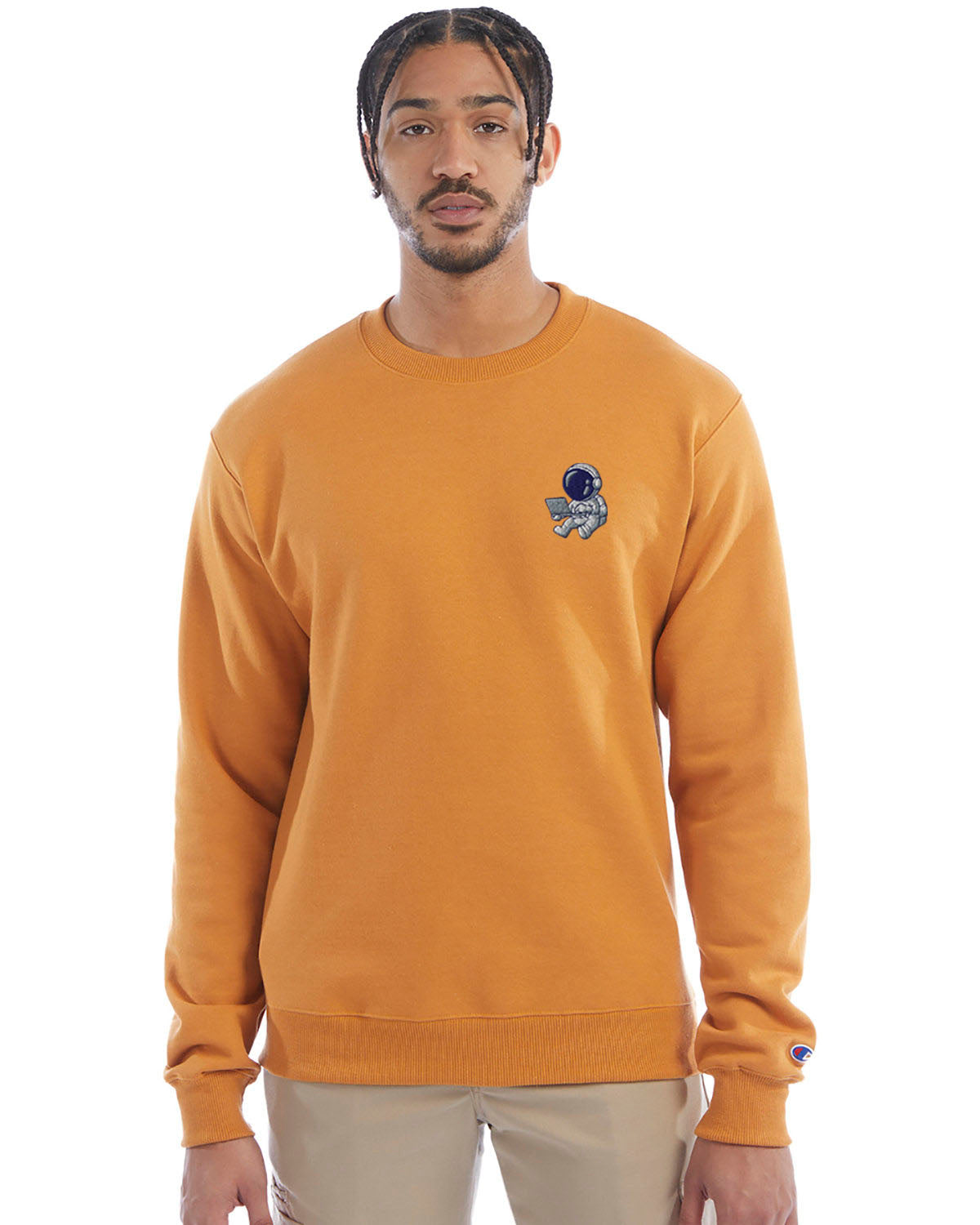 Model wearing gold glint Champion crewneck sweatshirt with custom chest logo.