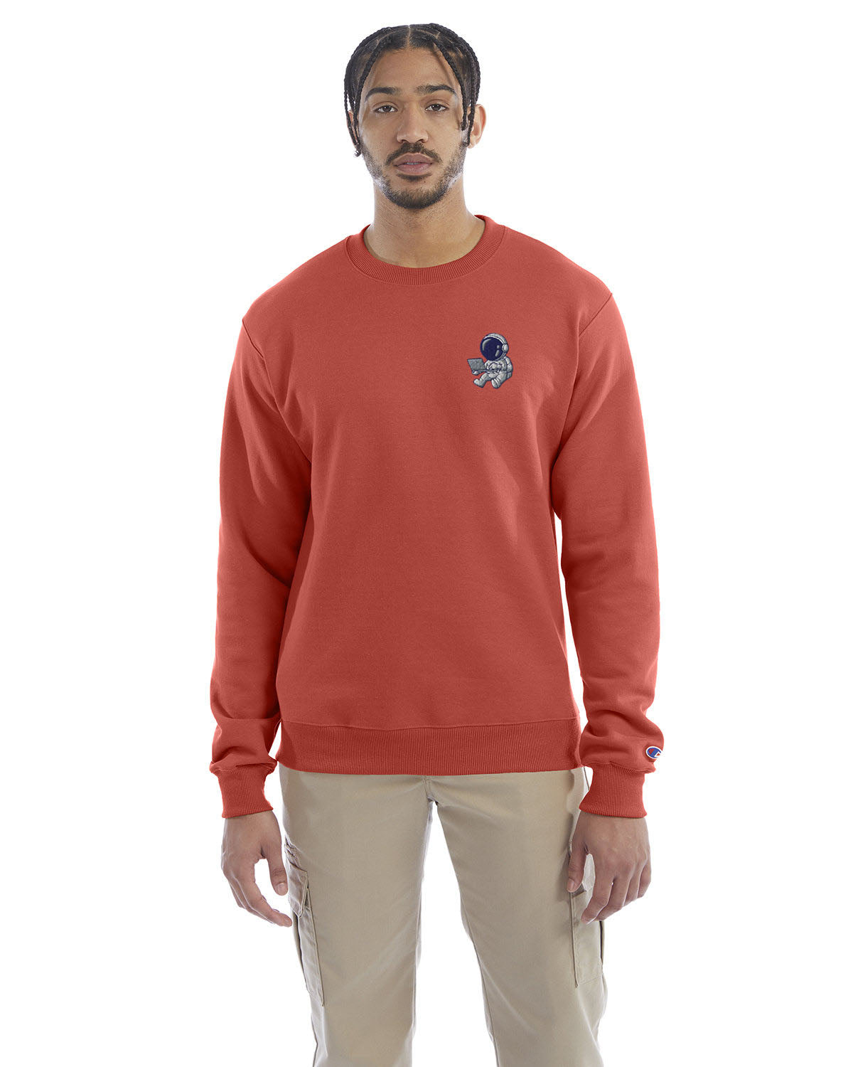 Model wearing red river clay Champion crewneck sweatshirt with custom chest logo.