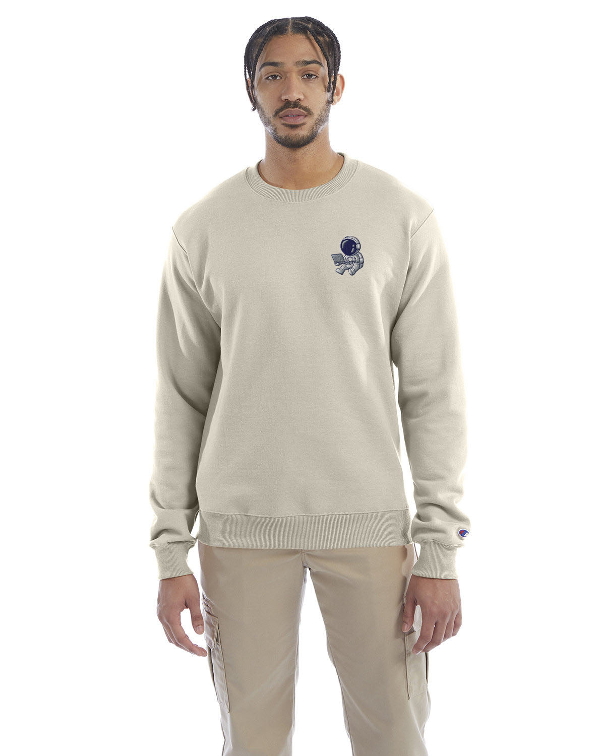 Model wearing sand Champion crewneck sweatshirt with custom chest logo.