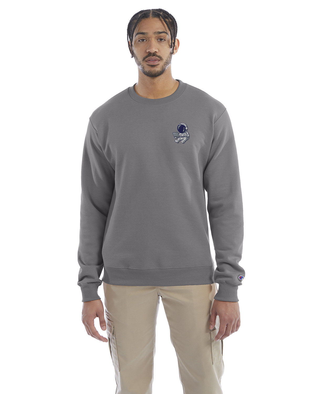 Model wearing stone gray Champion crewneck sweatshirt with custom chest logo.