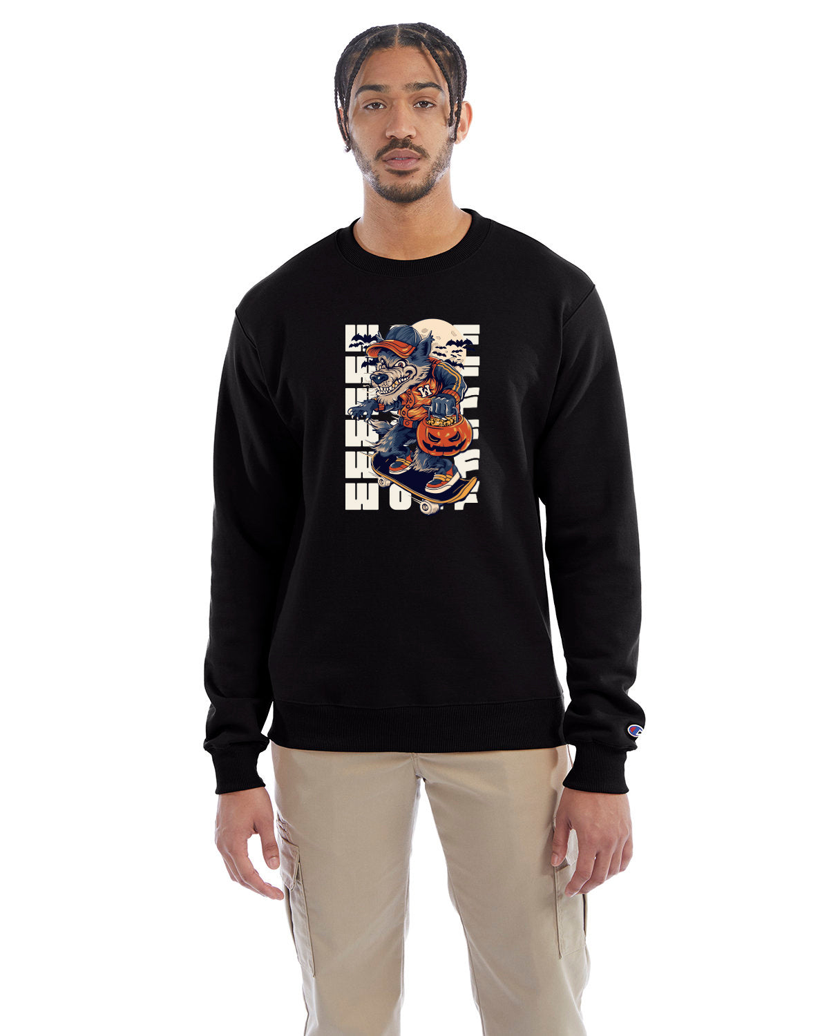 Black crewneck sweatshirt with a Halloween-themed graphic of a cartoon werewolf skateboarding with a pumpkin basket, worn by a model in beige pants.