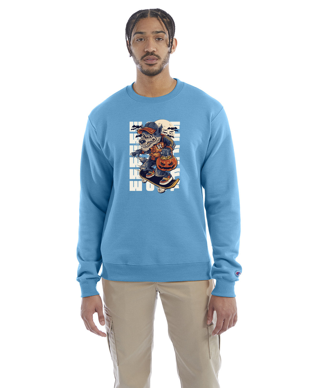 Blue lagoon crewneck sweatshirt with a Halloween-themed graphic of a cartoon werewolf skateboarding with a pumpkin basket, worn by a model in beige pants.