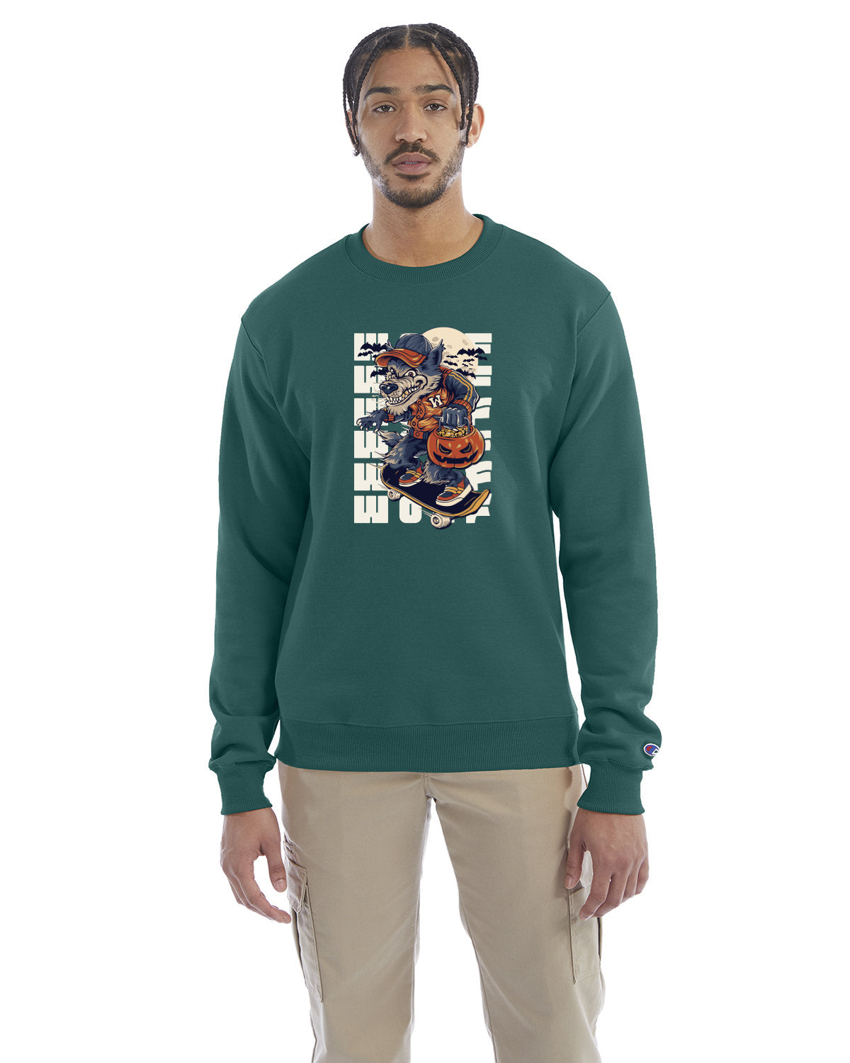 Emerald green crewneck sweatshirt with a Halloween-themed graphic of a cartoon werewolf skateboarding with a pumpkin basket, worn by a model in beige pants.