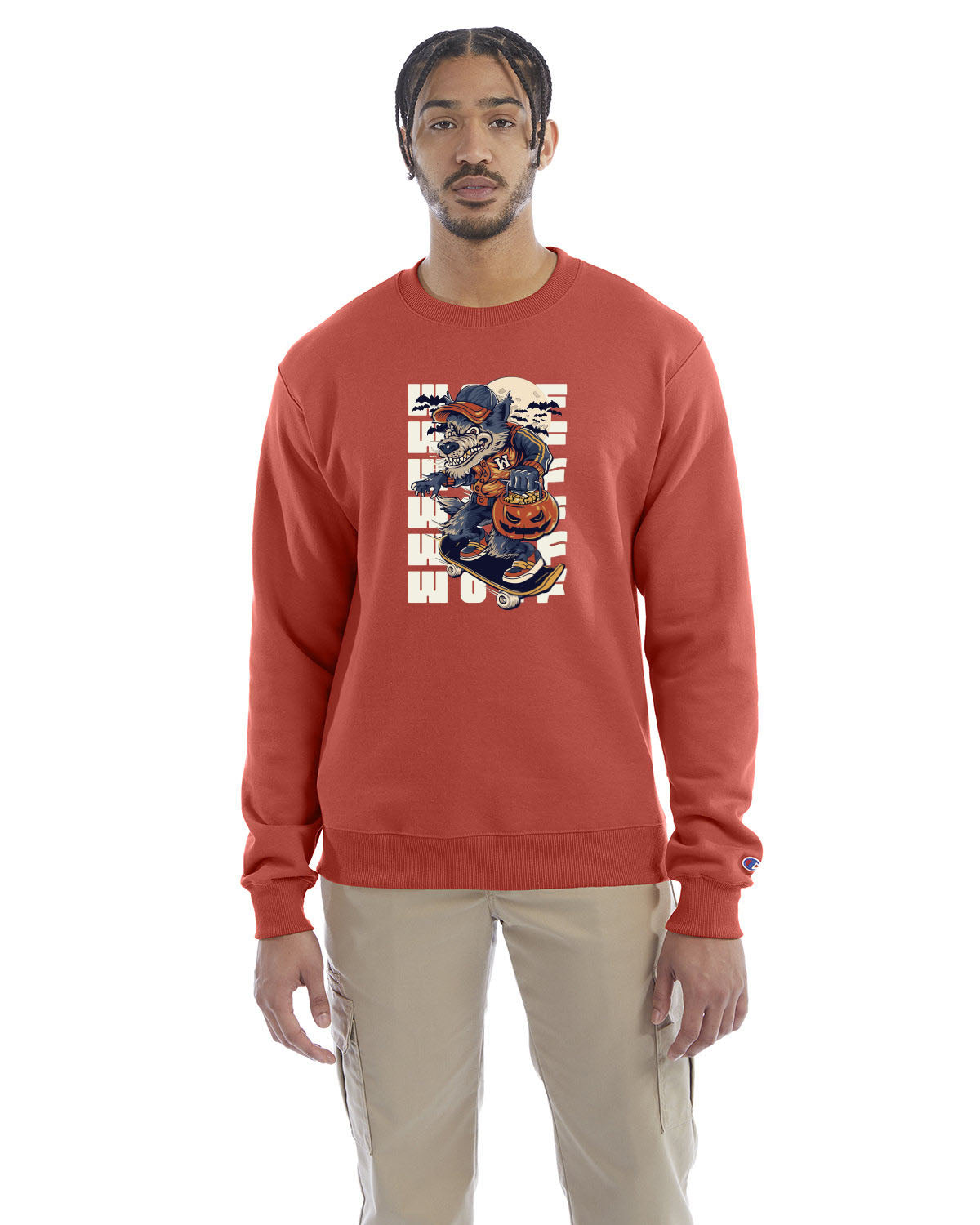 Red riverclay crewneck sweatshirt with a Halloween-themed graphic of a cartoon werewolf skateboarding with a pumpkin basket, worn by a model in beige pants.