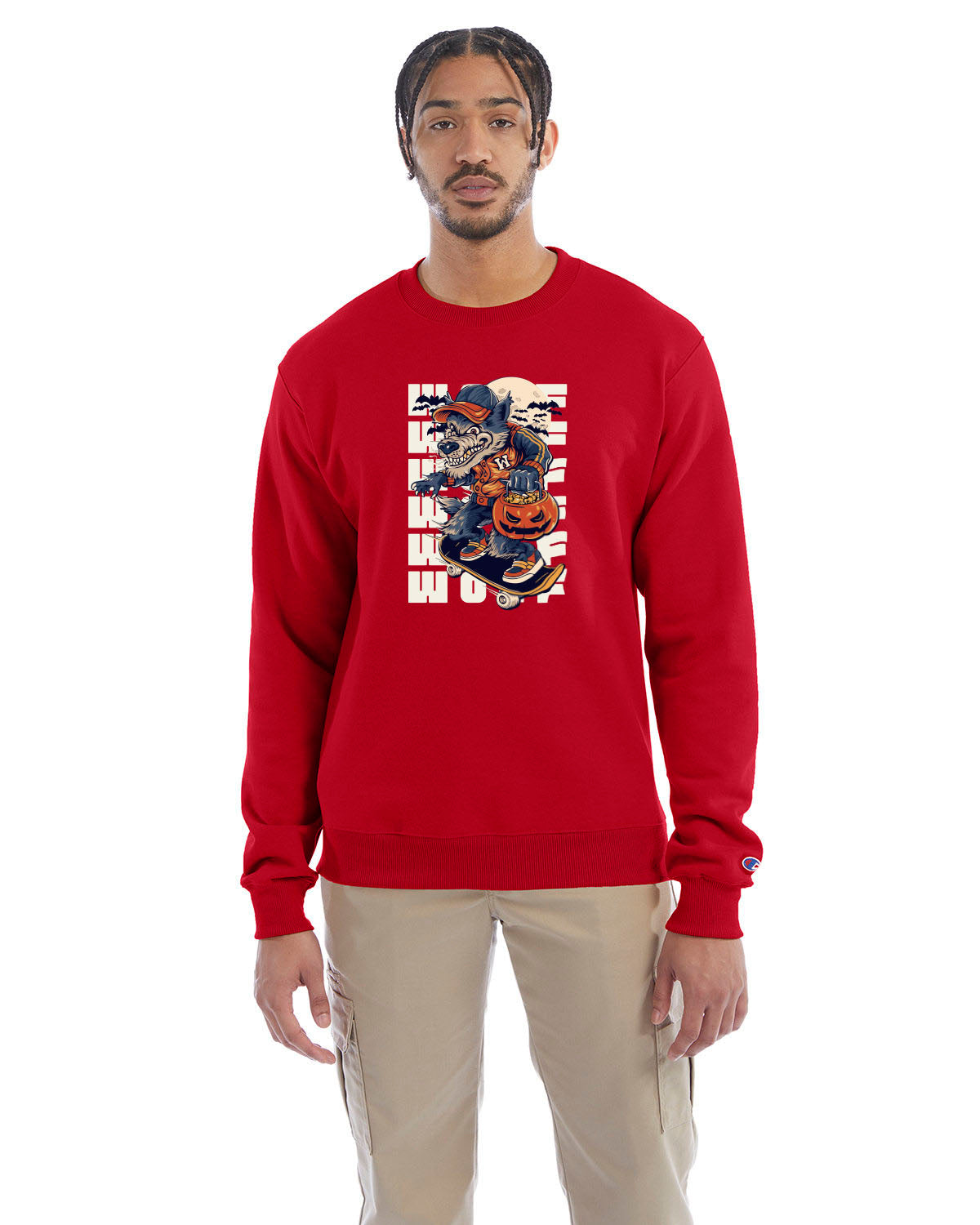 Scarlet crewneck sweatshirt with a Halloween-themed graphic of a cartoon werewolf skateboarding with a pumpkin basket, worn by a model in beige pants.