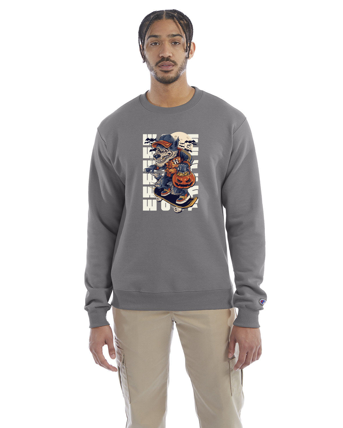 Stone gray crewneck sweatshirt with a Halloween-themed graphic of a cartoon werewolf skateboarding with a pumpkin basket, worn by a model in beige pants.
