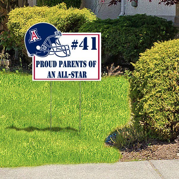 Custom football yard sign with helmet graphic and text displayed on lawn with H-stake