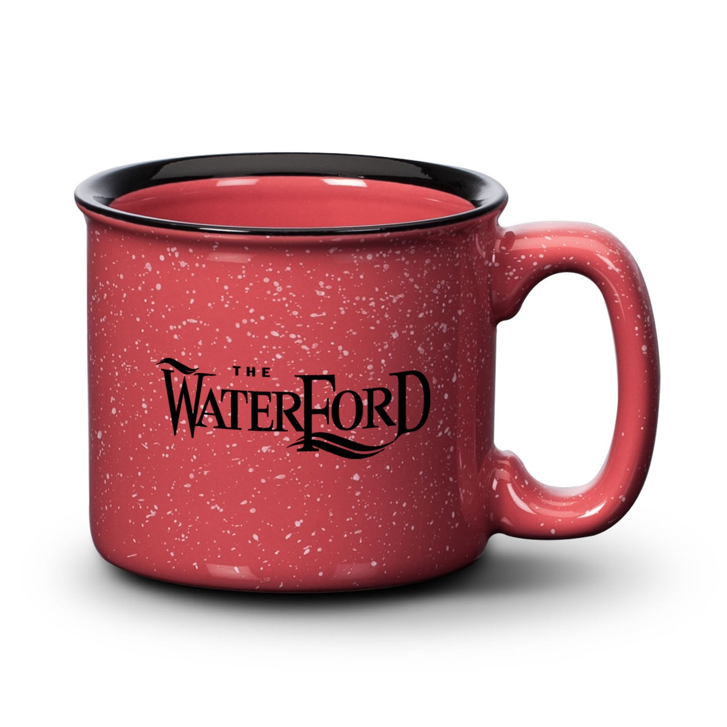 Coral silk ceramic campfire mug with a speckled finish, black rim, and “The Waterford” logo in bold print.