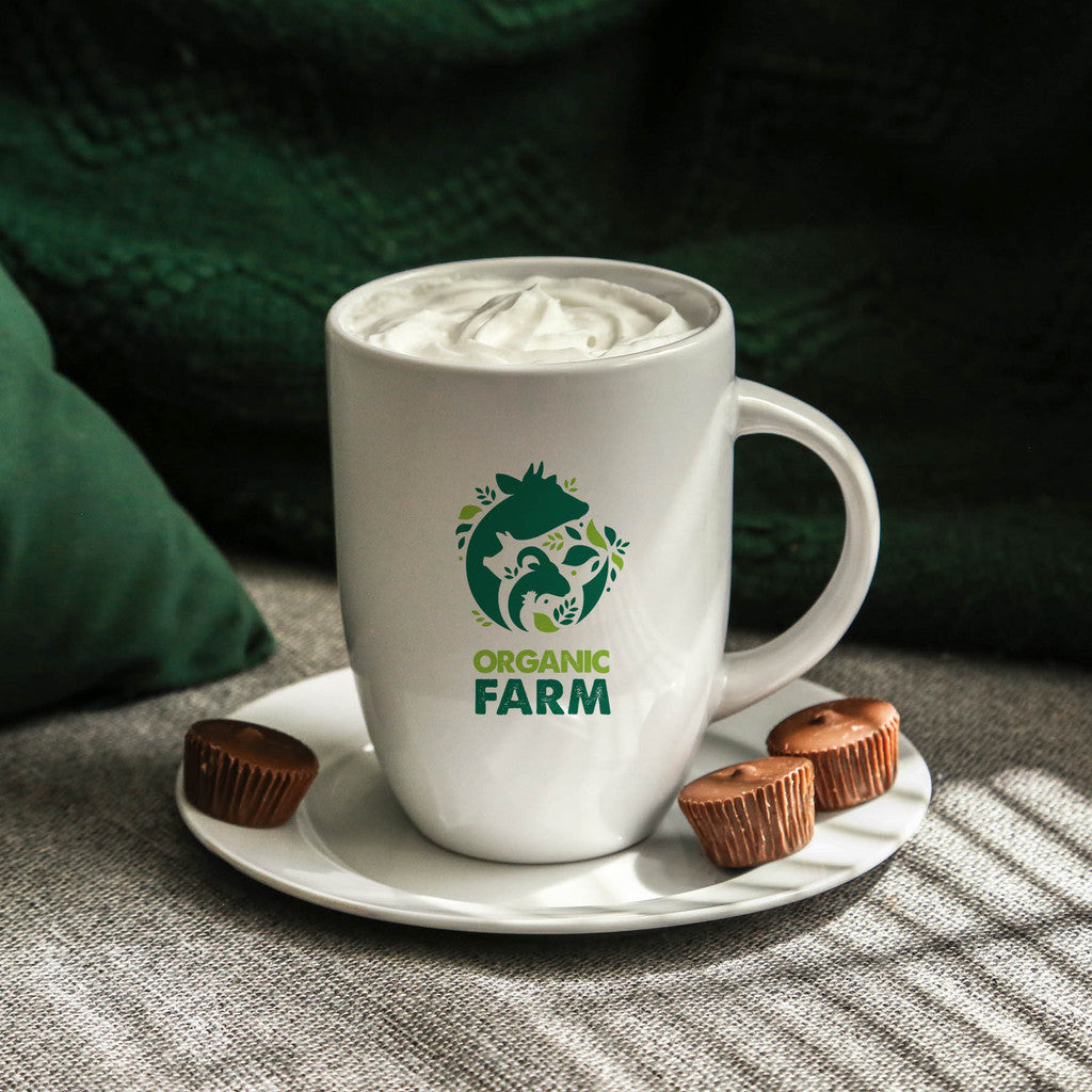 White ceramic mug with a tall profile, featuring a green logo on the front