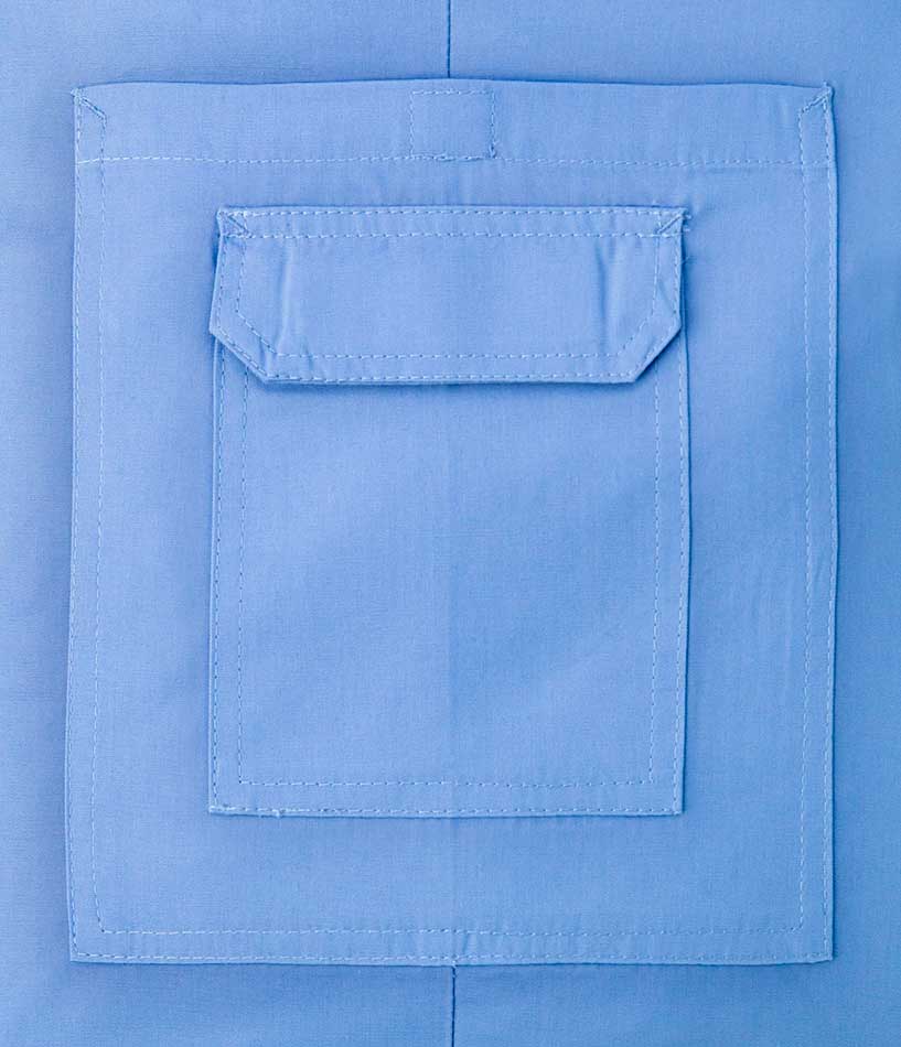Close-up of a light blue cargo scrub pocket with a flap closure and reinforced stitching.