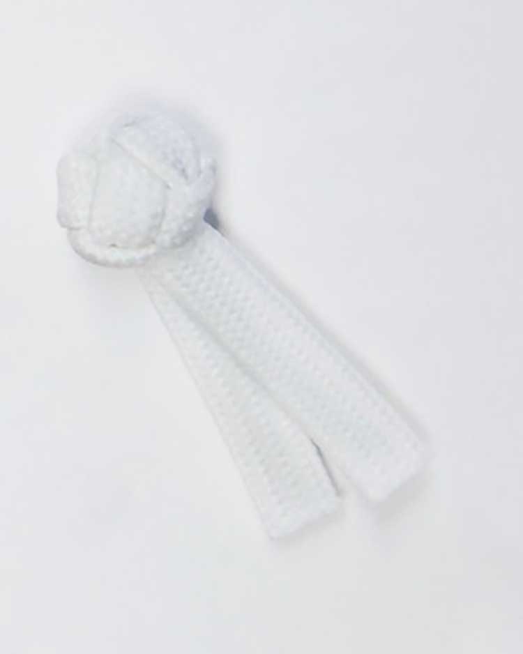 White knotted fabric button with two hanging braided cords, commonly used on traditional chef coats as a decorative and functional closure.