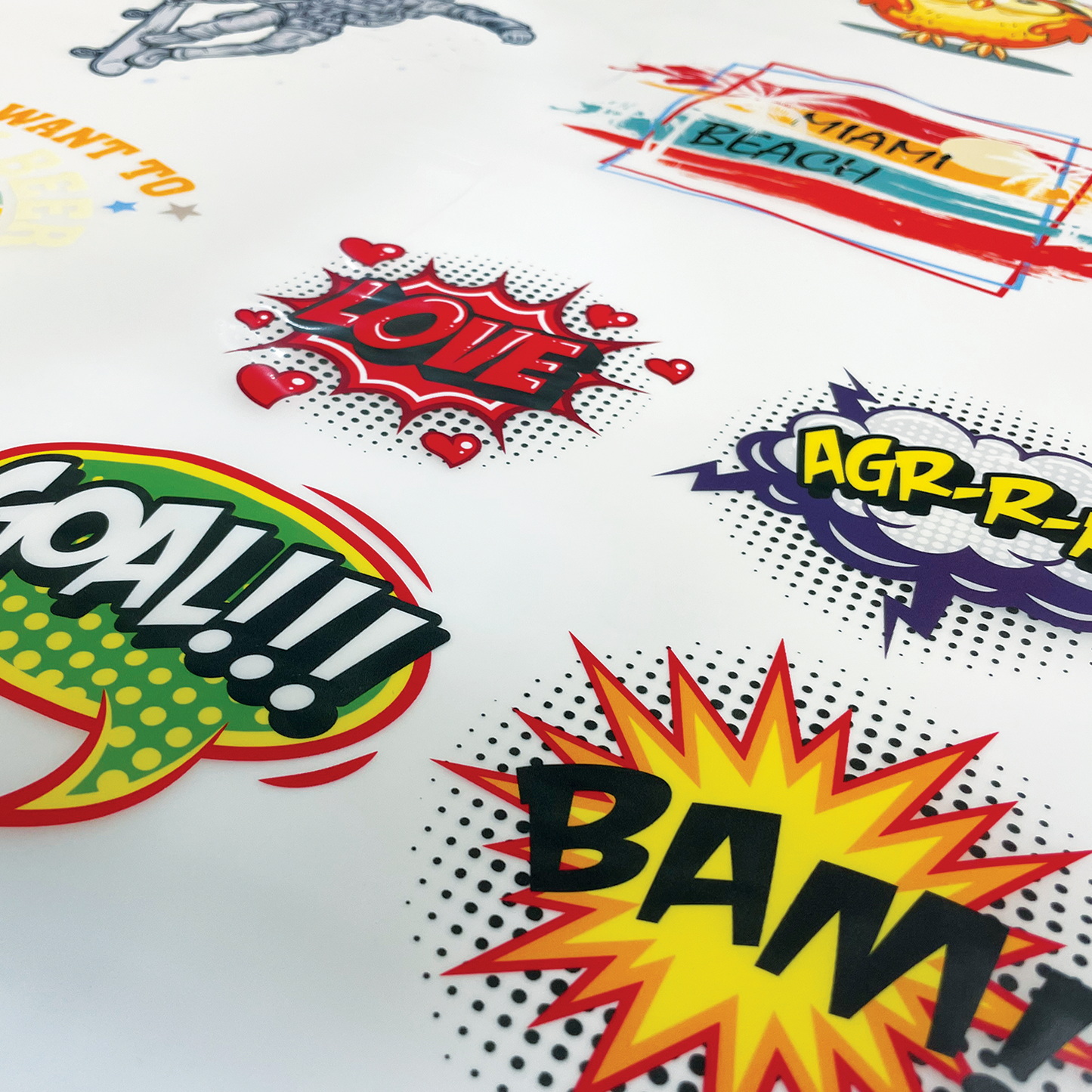 A collection of colorful Custom DTF Heat Transfer Sheets with playful designs