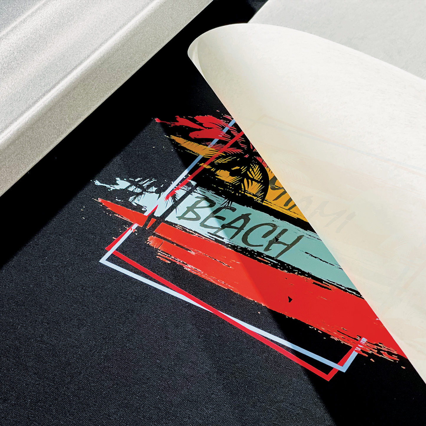A close-up of a Miami Beach-themed Custom DTF Heat Transfer Sheet being peeled off fabric