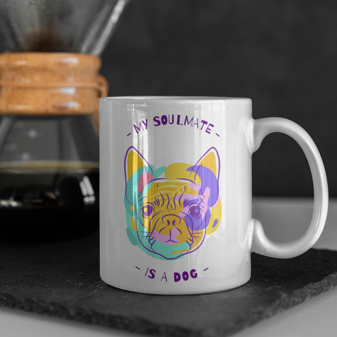 White ceramic mug with colorful dog illustration and the text "My Soulmate is a Dog" in playful purple font.