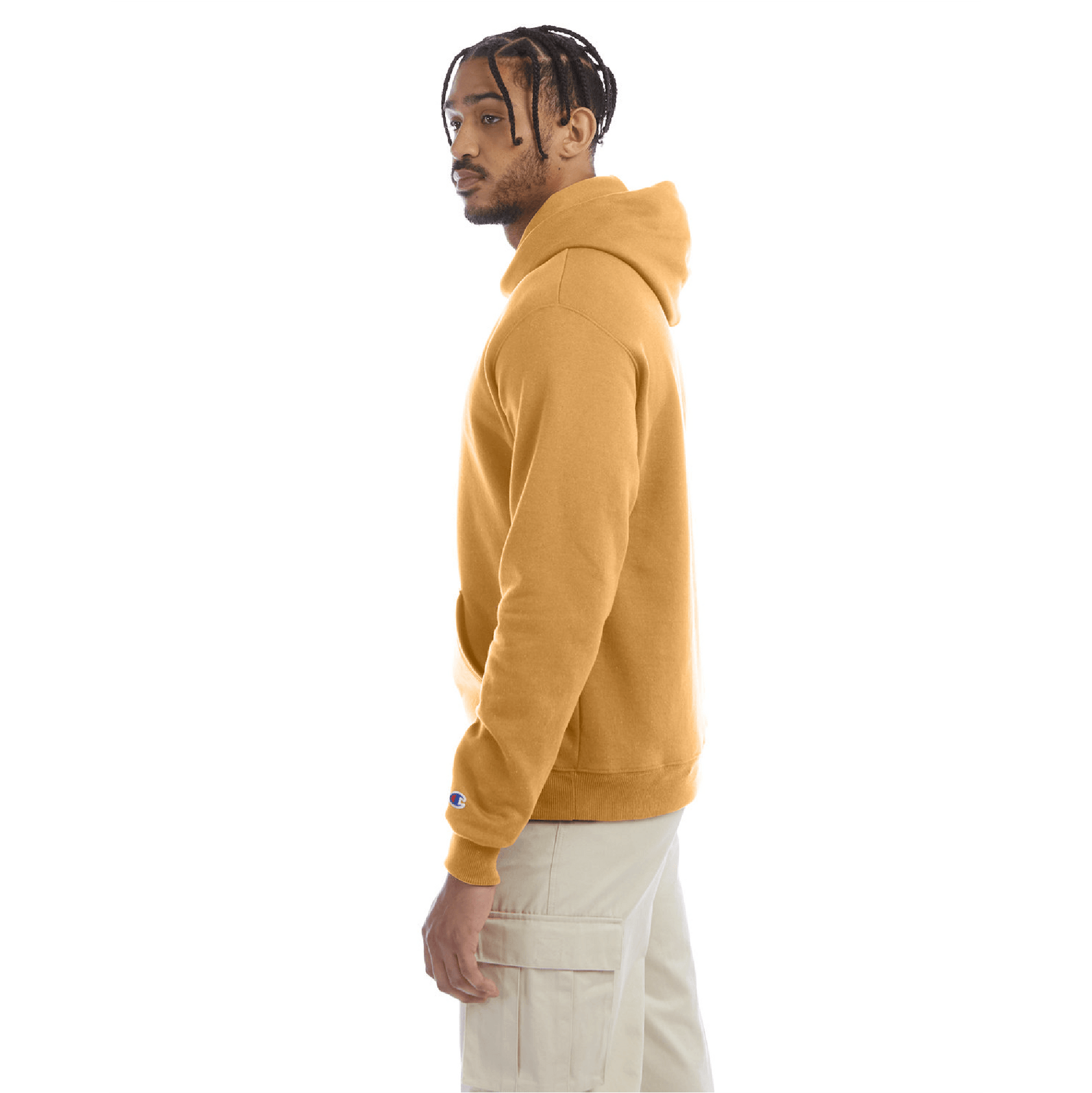 Side view of a golden brown Champion hoodie paired with beige cargo pants, showing the hoodie’s fit and sleeve logo.