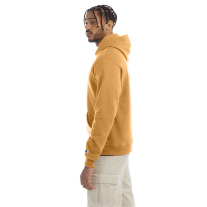 Side view of a golden brown Champion hoodie paired with beige cargo pants, showing the hoodie’s fit and sleeve logo.