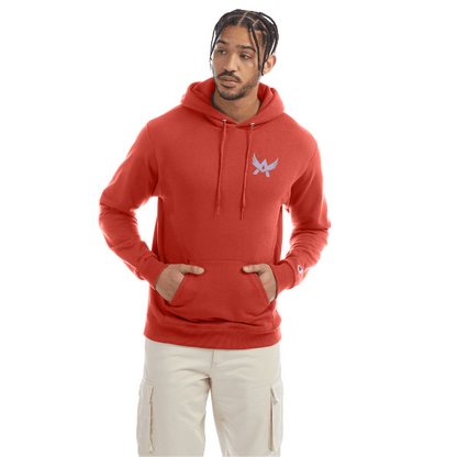 Model wearing a red Champion hoodie with a blue abstract winged logo on the left chest, front kangaroo pocket, and beige cargo pants.