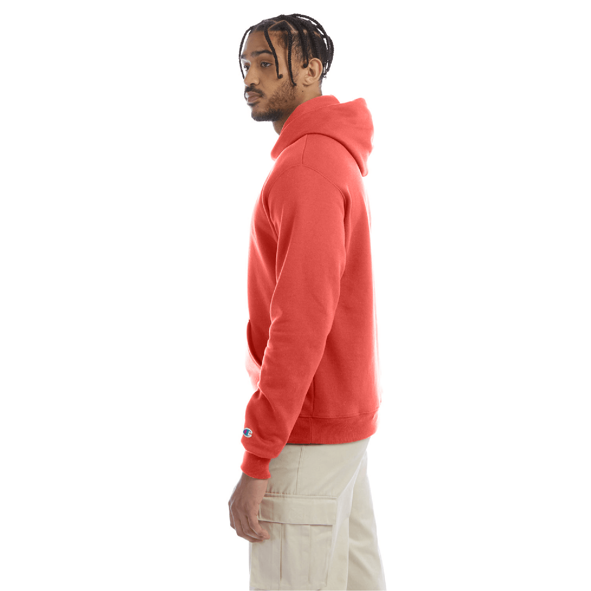 Side view of a red Champion hoodie worn with beige cargo pants, showing the hoodie’s relaxed fit, ribbed hem, and the Champion “C” logo on the sleeve.