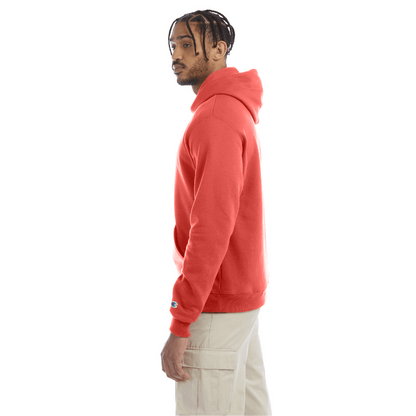 Side view of a red Champion hoodie worn with beige cargo pants, showing the hoodie’s relaxed fit, ribbed hem, and the Champion “C” logo on the sleeve.