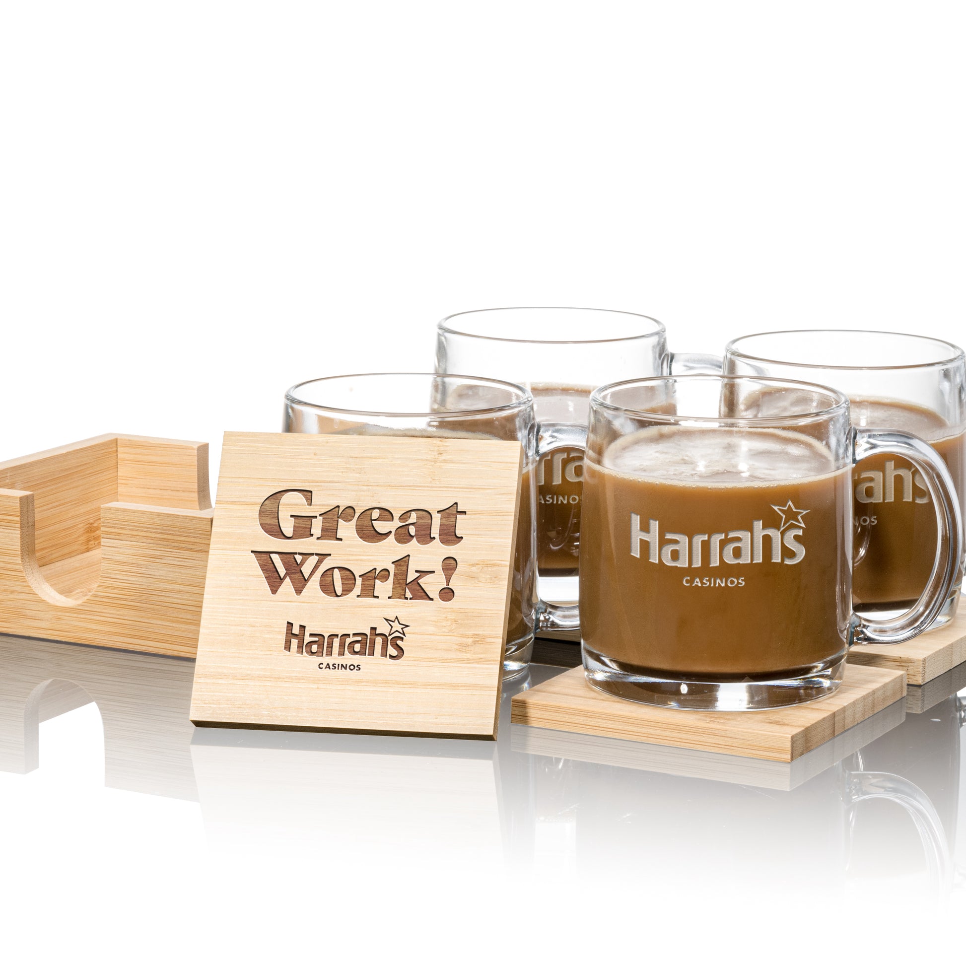 Set of four clear glass mugs with "Harrah's Casinos" logo, placed on square wooden coasters
