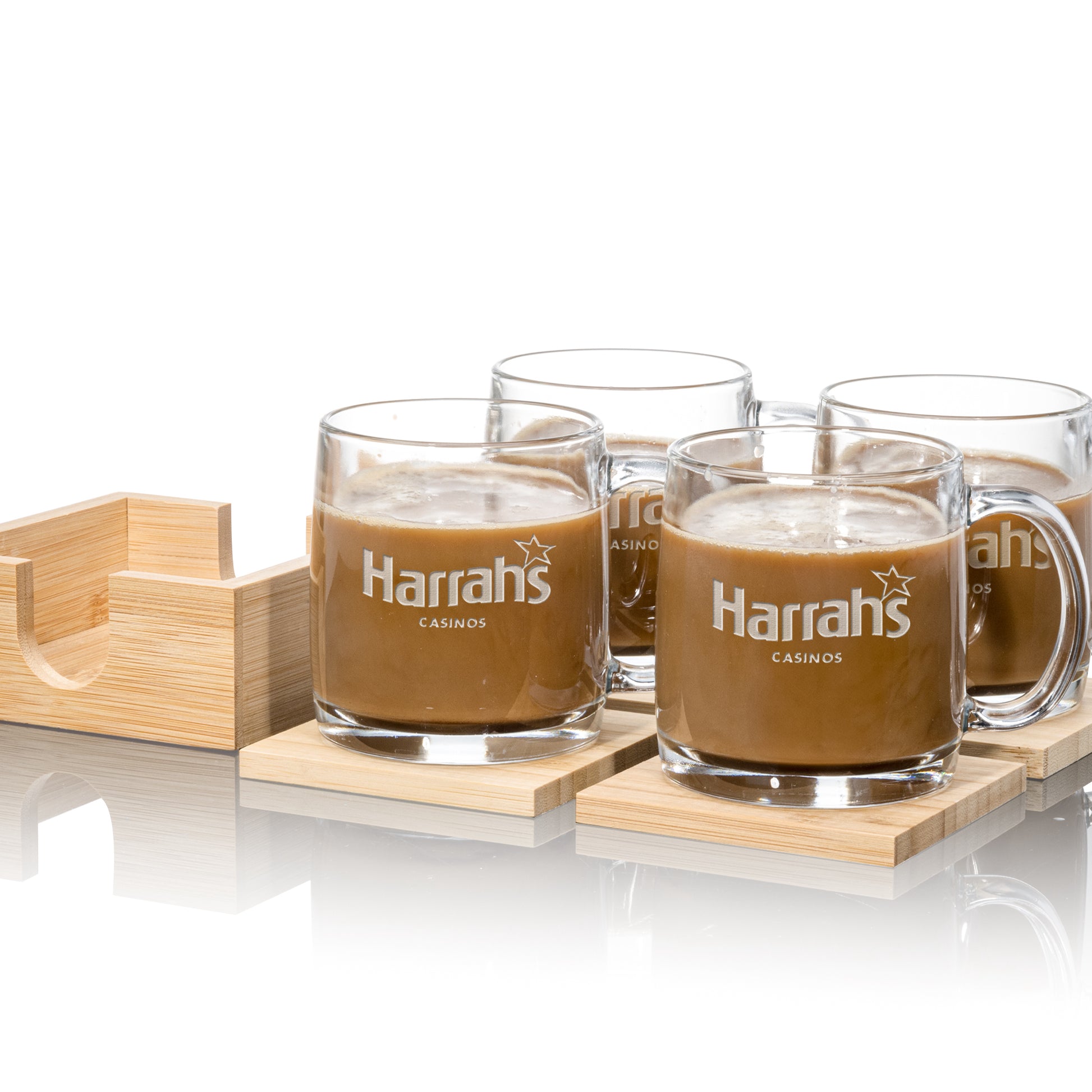 Set of four clear glass mugs with "Harrah's Casinos" logo, placed on square wooden coasters